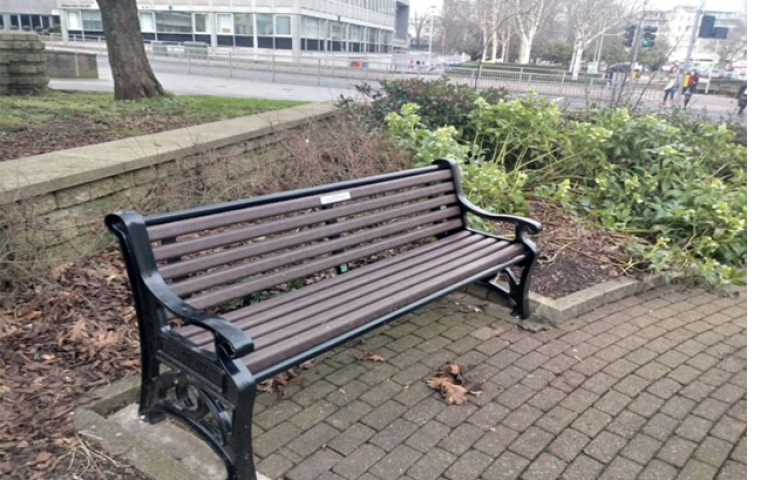 Memorial bench within earshot of the traffic on Royal Parade in Plymouth