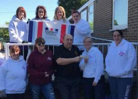 Nigel Mellor and ladies presenting a cheque