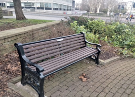 Memorial bench within earshot of the traffic on Royal Parade in Plymouth