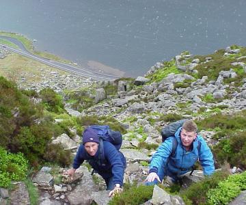 Paddy and another male climbing a mountain
